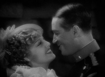 Movie still from “The Merry Widow” (1934), directed by Ernst Lubitsch – A man and a woman are smiling at each other; Close Up shot, High angle