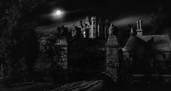 Movie still from “The Mirror Crack'd” (1980), directed by Guy Hamilton – A black and white photo of a castle at night; Extreme Wide shot, Low angle