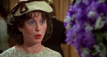 Movie still from “The Mirror Crack'd” (1980), directed by Guy Hamilton – A person wearing a hat; Close Up shot, Over the shoulder angle