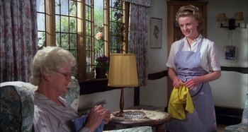 Movie still from “The Mirror Crack'd” (1980), directed by Guy Hamilton – Two women are sitting in a living room; Medium shot, Low angle