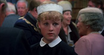 Movie still from “The Mirror Crack'd” (1980), directed by Guy Hamilton – A young boy wearing a white hat and a black shirt; Close Up shot, High angle