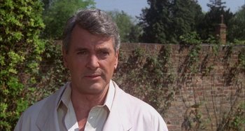 Movie still from “The Mirror Crack'd” (1980), directed by Guy Hamilton – An older man in a white dress shirt; Close Up shot, Low angle