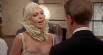 Movie still from “The Mirror Crack'd” (1980), directed by Guy Hamilton – A man and a woman in a white dress; Close Up shot, Over the shoulder angle