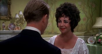 Movie still from “The Mirror Crack'd” (1980), directed by Guy Hamilton – A man and a woman talking to each other; Close Up shot, Over the shoulder angle