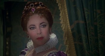 Movie still from “The Mirror Crack'd” (1980), directed by Guy Hamilton – A person wearing a dress; Close Up shot, Over the shoulder angle