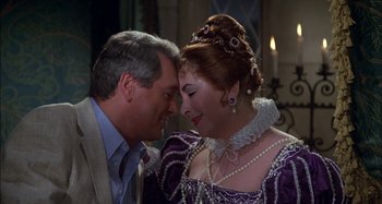 Movie still from “The Mirror Crack'd” (1980), directed by Guy Hamilton – A man and a woman in formal clothing; Medium shot, Over the shoulder angle