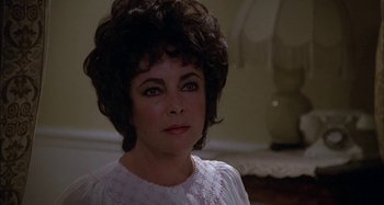 Movie still from “The Mirror Crack'd” (1980), directed by Guy Hamilton – A person wearing a white shirt; Close Up shot, Over the shoulder angle