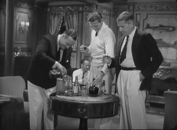 Movie still from “The Most Dangerous Game” (1932), directed by Irving Pichel – A group of men standing in front of a table; Medium shot, High angle