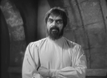Movie still from “The Most Dangerous Game” (1932), directed by Irving Pichel – Black and white photograph of a man with a beard; Medium shot, Over the shoulder angle