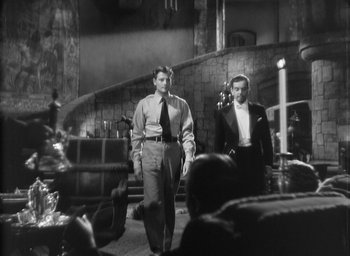 Movie still from “The Most Dangerous Game” (1932), directed by Irving Pichel – Two men are standing in front of an audience; Medium shot, Low angle