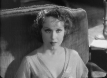 Movie still from “The Most Dangerous Game” (1932), directed by Irving Pichel – An old black and white photo of a woman sitting in a chair; Close Up shot, High angle