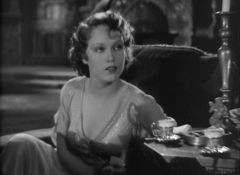 Movie still from “The Most Dangerous Game” (1932), directed by Irving Pichel – A woman sitting at a table with a cup of coffee; Close Up shot, High angle