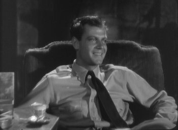 Movie still from “The Most Dangerous Game” (1932), directed by Irving Pichel – A black and white photo of a man sitting in a chair; Medium shot, Low angle