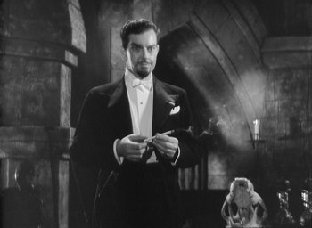 Movie still from “The Most Dangerous Game” (1932), directed by Irving Pichel – A man in a tuxedo holding a knife in his hands; Medium shot, Low angle