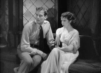 Movie still from “The Most Dangerous Game” (1932), directed by Irving Pichel – A man and a woman sitting next to each other on a bench; Medium shot, High angle