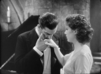 Movie still from “The Most Dangerous Game” (1932), directed by Irving Pichel – A man and a woman touching their noses; Medium shot, High angle