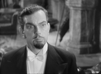 Movie still from “The Most Dangerous Game” (1932), directed by Irving Pichel – A black and white photo of a man in a tuxedo; Close Up shot, High angle