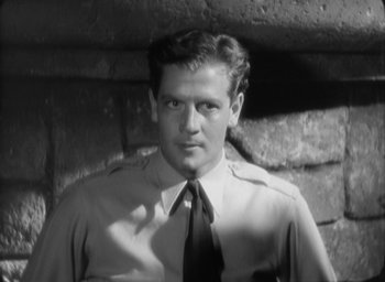 Movie still from “The Most Dangerous Game” (1932), directed by Irving Pichel – Black and white photograph of a man wearing a tie; Close Up shot, Low angle