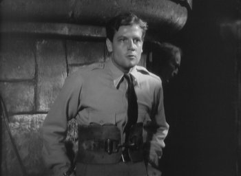 Movie still from “The Most Dangerous Game” (1932), directed by Irving Pichel – A black and white photo of a man in a uniform; Medium shot, Low angle