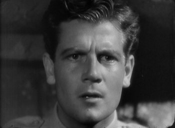 Movie still from “The Most Dangerous Game” (1932), directed by Irving Pichel – An old black and white photo of a man's face; Close Up shot, Over the shoulder angle