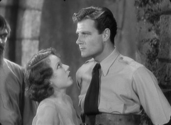 Movie still from “The Most Dangerous Game” (1932), directed by Irving Pichel – A man and a woman standing next to each other; Medium shot, Low angle