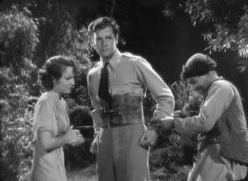 Movie still from “The Most Dangerous Game” (1932), directed by Irving Pichel – A man and two women standing next to each other in a field; Medium shot, Low angle