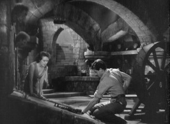 Movie still from “The Most Dangerous Game” (1932), directed by Irving Pichel – A group of people standing around in a room; Wide shot, High angle