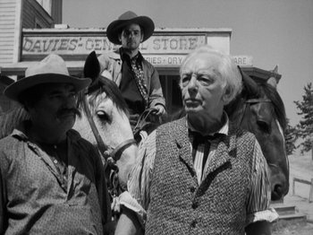 Movie still from “The Ox-Bow Incident” (1942), directed by William A. Wellman – Two men on horses in front of an old store; Medium shot, Low angle