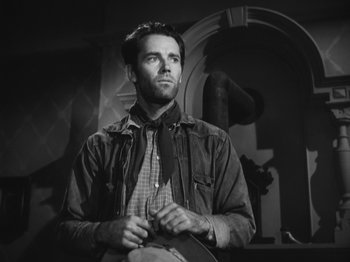 Movie still from “The Ox-Bow Incident” (1942), directed by William A. Wellman – Black and white photograph of a man with a bow tie looking up; Medium shot, Low angle