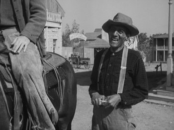 Movie still from “The Ox-Bow Incident” (1942), directed by William A. Wellman – An older man standing next to a horse; Medium shot, Over the shoulder angle