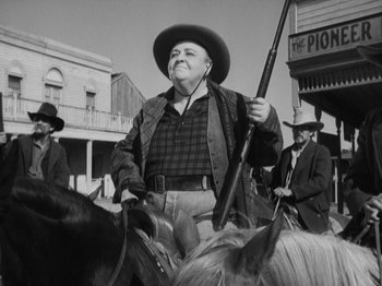 Movie still from “The Ox-Bow Incident” (1942), directed by William A. Wellman – An old photo of a man holding a rifle on a horse; Medium shot, Low angle