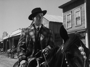 Movie still from “The Ox-Bow Incident” (1942), directed by William A. Wellman – A black and white photo of a man riding a horse; Medium shot, Low angle