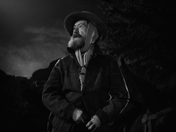 Movie still from “The Ox-Bow Incident” (1942), directed by William A. Wellman – A man with a beard and a cowboy hat; Medium shot, Low angle