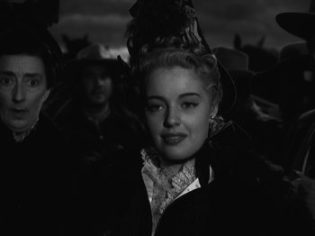 Movie still from “The Ox-Bow Incident” (1942), directed by William A. Wellman – A black and white photo of a woman in a cowboy hat; Close Up shot, Low angle