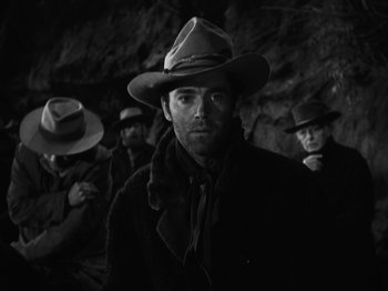 Movie still from “The Ox-Bow Incident” (1942), directed by William A. Wellman – A black and white photo of a man wearing a hat; Medium shot, Low angle