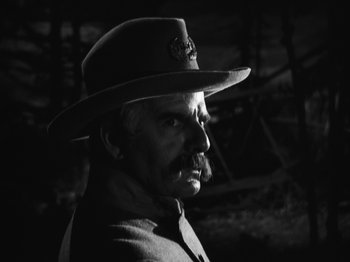 Movie still from “The Ox-Bow Incident” (1942), directed by William A. Wellman – A man with a hat and a mustache in a black and white photo; Close Up shot, Low angle