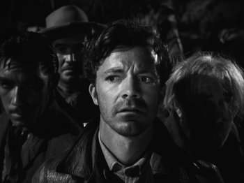 Movie still from “The Ox-Bow Incident” (1942), directed by William A. Wellman – A black and white photo of a man in a crowd of people; Close Up shot, Over the shoulder angle