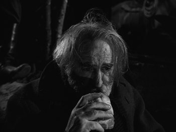 Movie still from “The Ox-Bow Incident” (1942), directed by William A. Wellman – An old man is eating a piece of food; Close Up shot, High angle