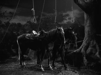 Movie still from “The Ox-Bow Incident” (1942), directed by William A. Wellman – A group of horses standing next to each other; Wide shot, Low angle