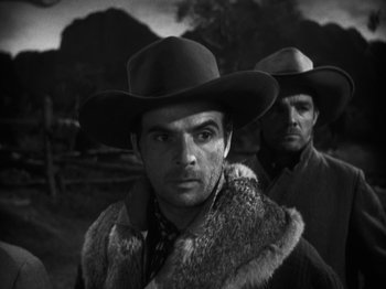 Movie still from “The Ox-Bow Incident” (1942), directed by William A. Wellman – A man in a cowboy hat standing next to another man; Close Up shot, Low angle