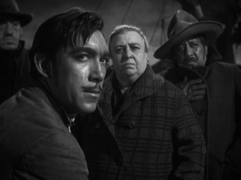 Movie still from “The Ox-Bow Incident” (1942), directed by William A. Wellman – A group of men standing next to each other; Close Up shot, Low angle