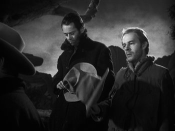 Movie still from “The Ox-Bow Incident” (1942), directed by William A. Wellman – Two men standing next to each other on a field; Medium shot, Low angle