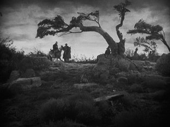 Movie still from “The Ox-Bow Incident” (1942), directed by William A. Wellman – A black and white photo of people on horseback; Extreme Wide shot, Low angle