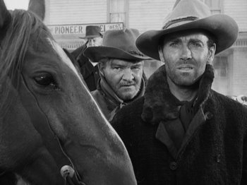 Movie still from “The Ox-Bow Incident” (1942), directed by William A. Wellman – A black and white photo of two men and a horse; Close Up shot, Low angle