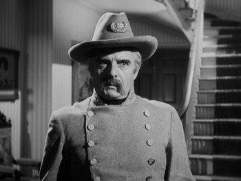 Movie still from “The Ox-Bow Incident” (1942), directed by William A. Wellman – An old photo of a man wearing a uniform and a hat; Close Up shot, Low angle
