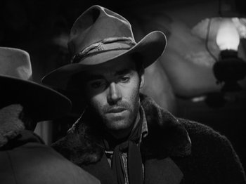 Movie still from “The Ox-Bow Incident” (1942), directed by William A. Wellman – A black and white photo of a man wearing a cowboy hat; Close Up shot, Over the shoulder angle