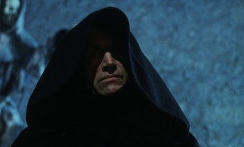Movie still from “The Pit and the Pendulum” (1991), directed by Stuart Gordon – A man in a black robe and a black hood; Close Up shot, Low angle