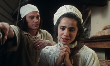 Movie still from “The Pit and the Pendulum” (1991), directed by Stuart Gordon – A man and a woman wearing white hats; Close Up shot, High angle