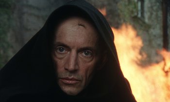 Movie still from “The Pit and the Pendulum” (1991), directed by Stuart Gordon – A person wearing a black robe; Close Up shot, High angle