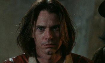 Movie still from “The Pit and the Pendulum” (1991), directed by Stuart Gordon – A person with long brown hair; Close Up shot, Low angle